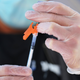 A medical staff member prepares a covid-19 shot at a vaccination pop-up site at the Life of Hope Center on Oct. 21, 2021 in New York City.